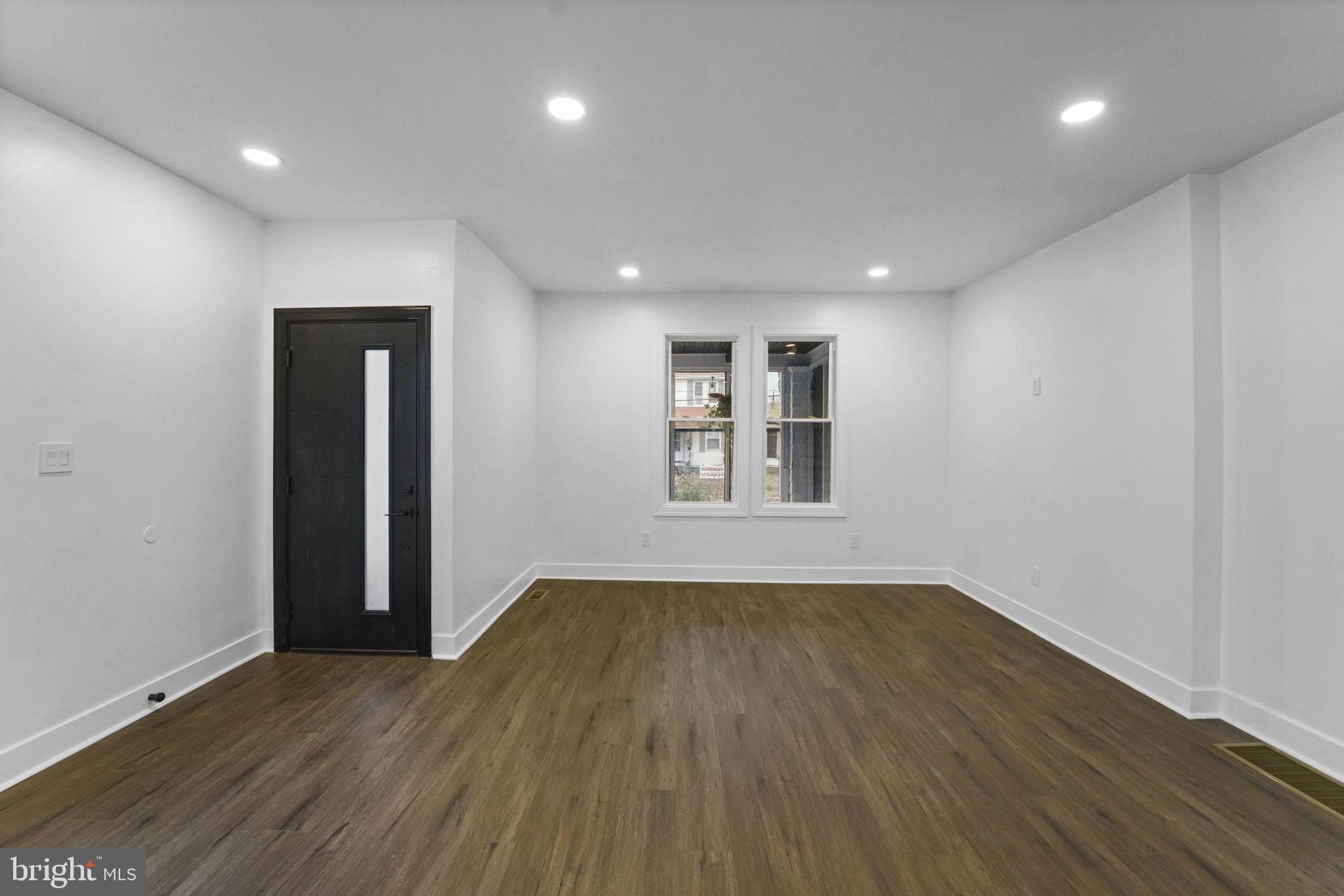 121 Parker Place Hamilton, NJ 08609 - Photo 5 of 37 an empty room with wooden floor and windows