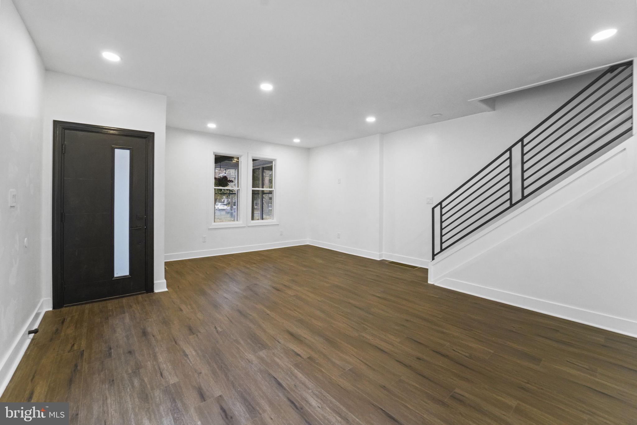 121 Parker Place Hamilton, NJ 08609 - Photo 9 of 37 an empty room with wooden floor and windows