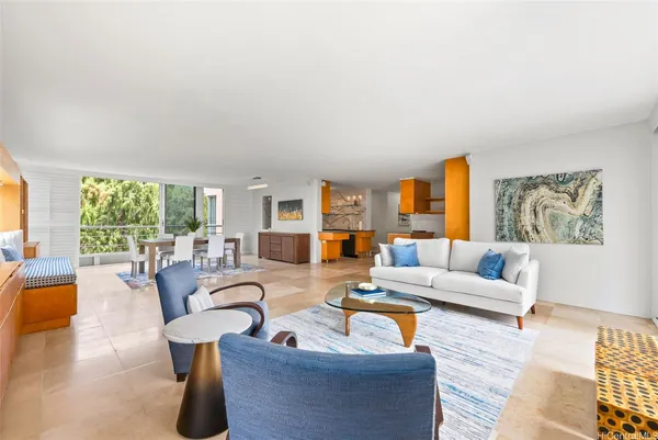a living room with furniture a large window and a table