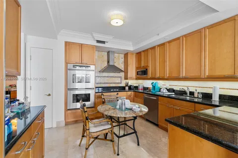a kitchen with granite countertop lots of counter top space and dining table