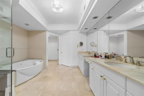 a spacious bathroom with a granite countertop sink a toilet a mirror and shower
