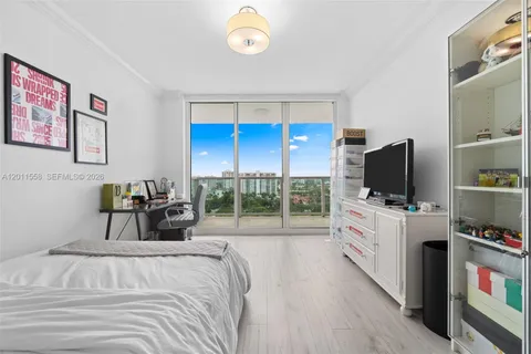 a bed room with furniture and a flat screen tv