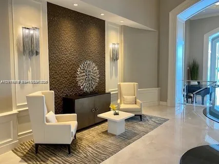 a living room with furniture fireplace and a large window