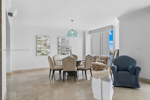a dining room with furniture and a chandelier