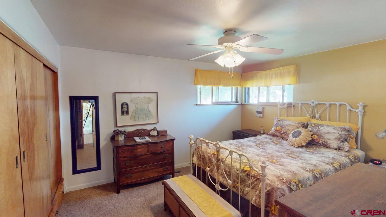 96 El Rio Drive Alamosa, CO 81101 - Photo 8 of 18 a bedroom with a bed and wooden floor