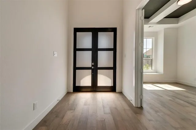 wooden floor in an empty room with a window