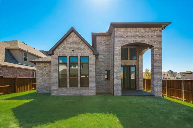 a view of a backyard with wooden fence