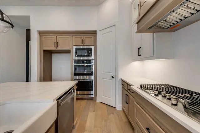 a kitchen with a stove and a refrigerator