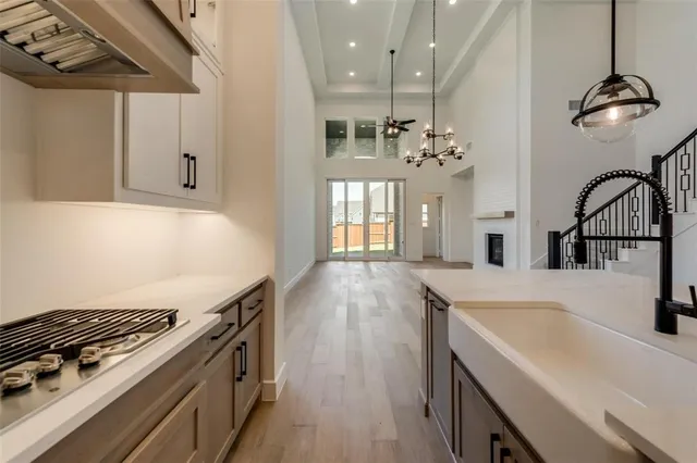 a kitchen that has a lot of cabinets and wooden floor