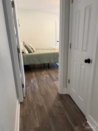 a room with wooden floor and furniture