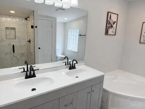 a bathroom with a sink a mirror and shower