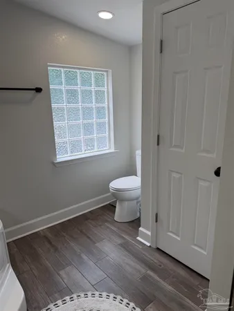 a view of wooden floor and a window in a room