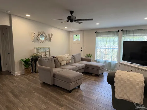 a living room with furniture and a flat screen tv