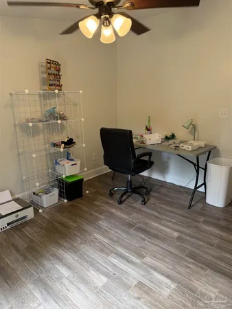 a view of a workspace with furniture and a bathroom