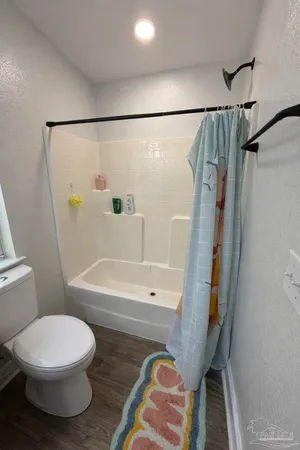 a bathroom with a toilet and a shower
