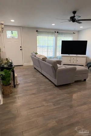 a living room with furniture and a flat screen tv