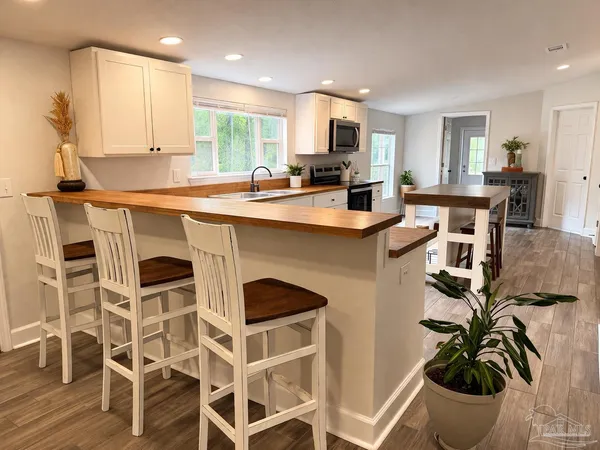a kitchen with a sink cabinets and window
