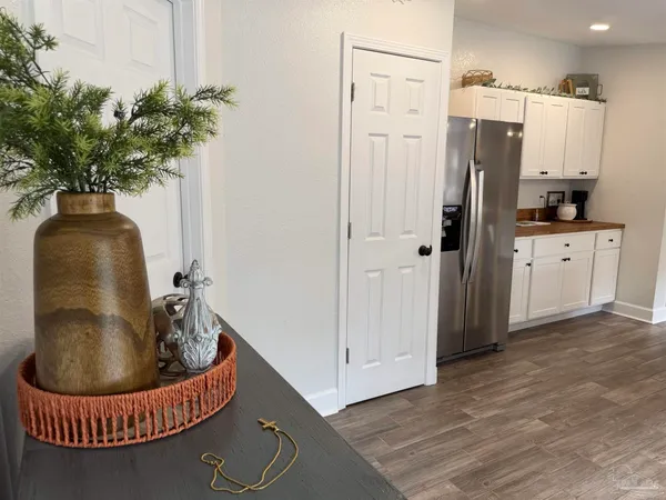 a kitchen with stainless steel appliances granite countertop a refrigerator a sink a counter space and a window