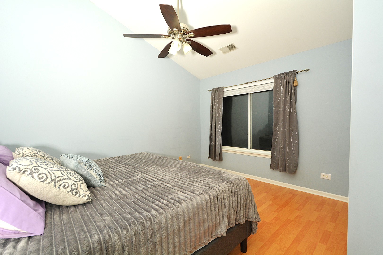 2974 Waters Edge Circle Aurora, IL 60504 - Photo 7 of 13 a bedroom with a bed and a chandelier