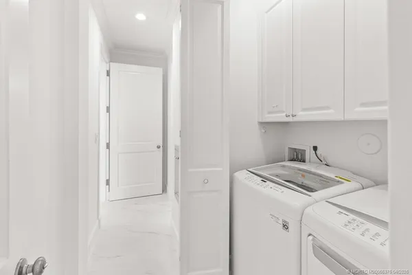 a view of a storage and utility room with washer and dryer