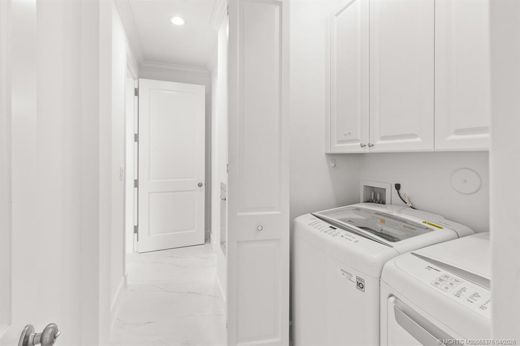 47 Southwest Osceola Street, Unit UN206 Stuart, FL 34994 - Photo 17 of 43 a view of a storage and utility room with washer and dryer
