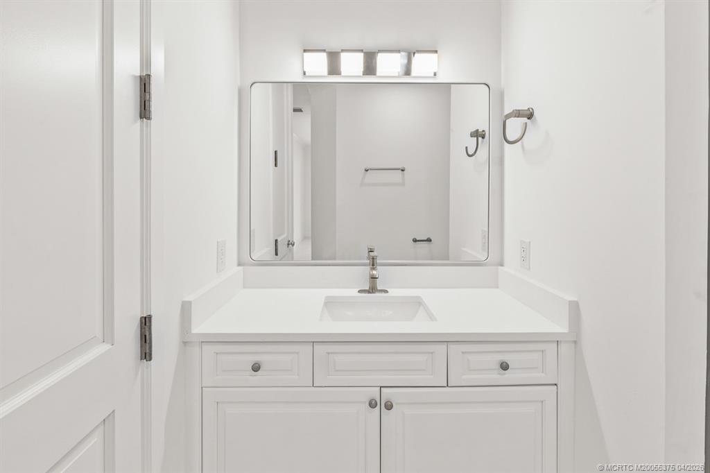 47 Southwest Osceola Street, Unit UN206 Stuart, FL 34994 - Photo 19 of 43 a bathroom with a sink and a mirror