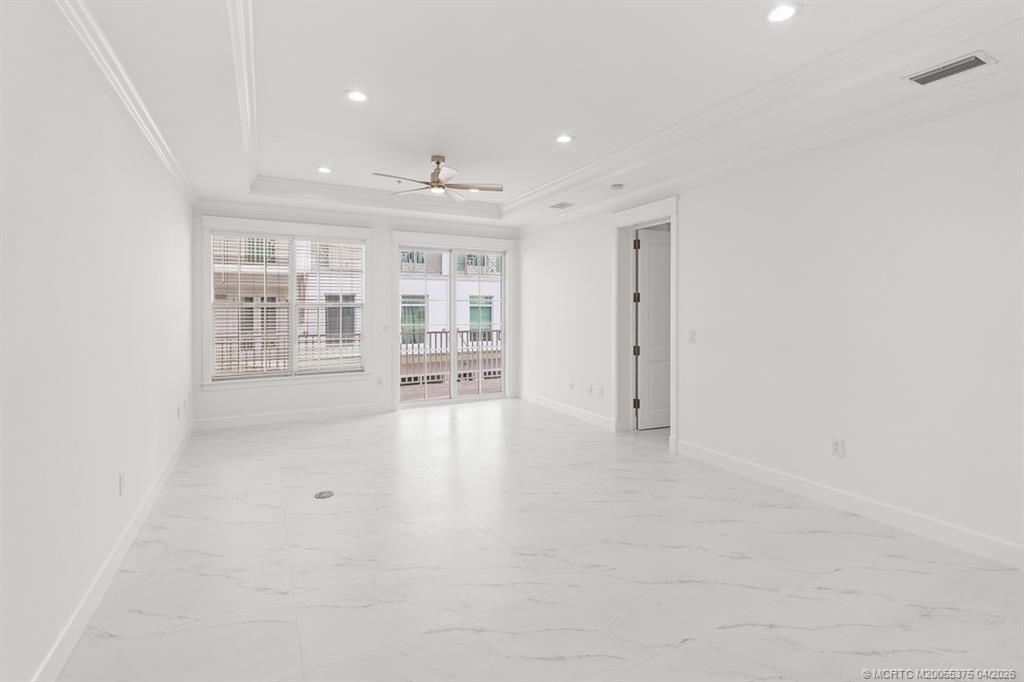 47 Southwest Osceola Street, Unit UN206 Stuart, FL 34994 - Photo 6 of 43 an empty room with windows and pillars in it