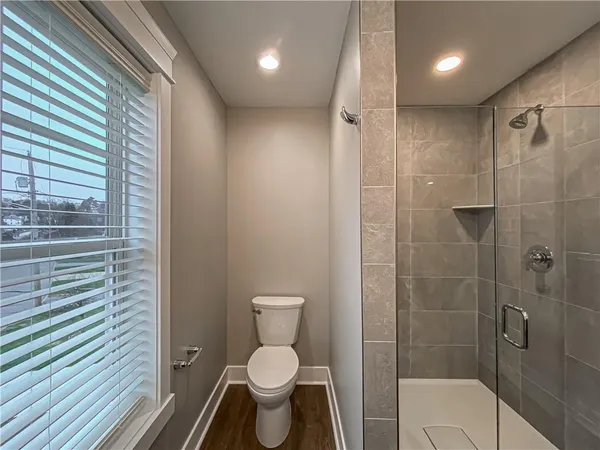 a bathroom with a toilet and a shower