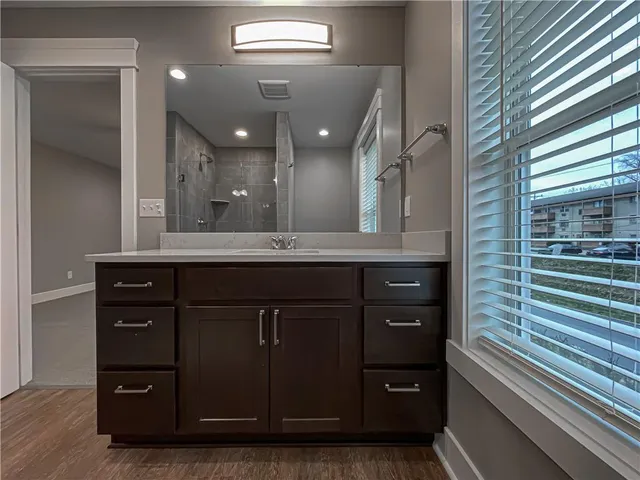 a bathroom with a sink a vanity and a large mirror