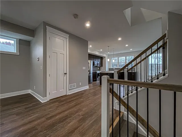 a view of entryway with wooden floor and stairs