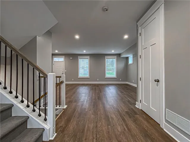 a view of entryway with wooden floor and stairs