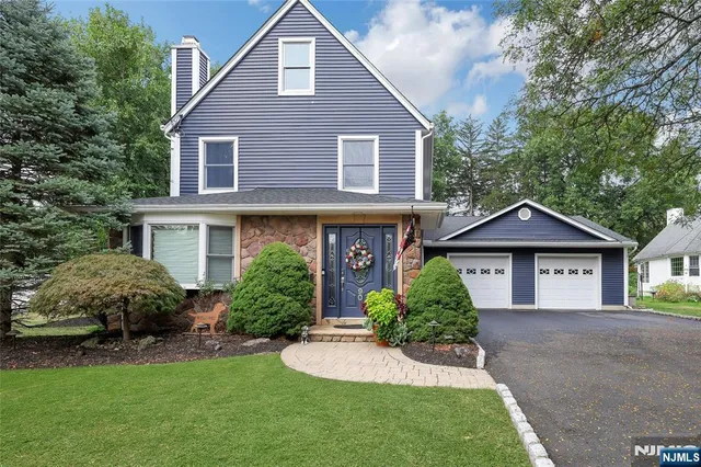 a front view of a house with a yard and porch