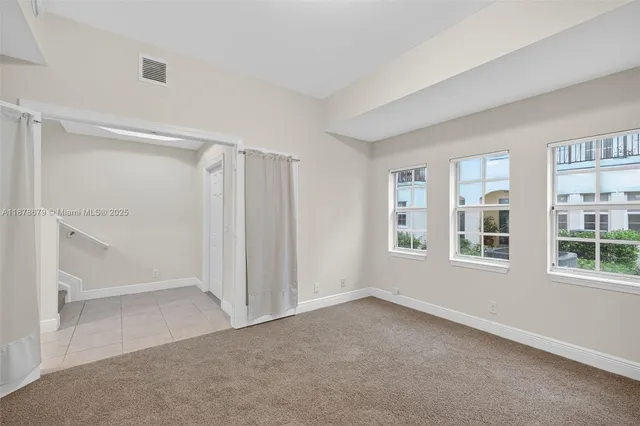 a view of a white house with a yard