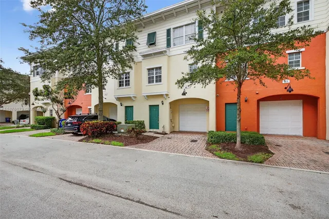 a view of a lake with a yard and a large tree