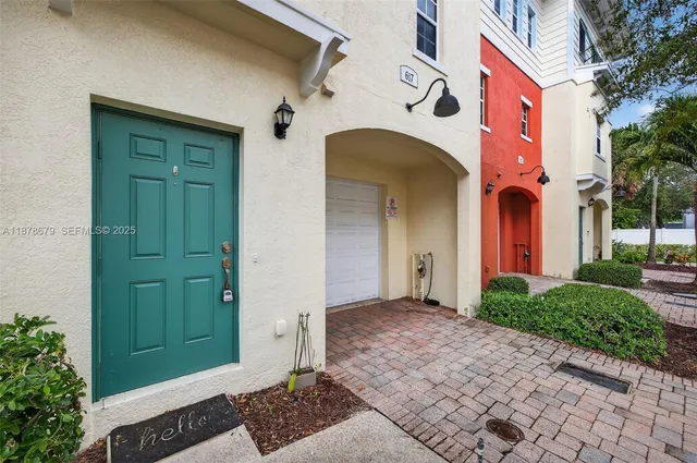 a view of a lake with a yard and a large tree
