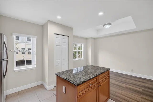 a kitchen with granite countertop cabinets and window