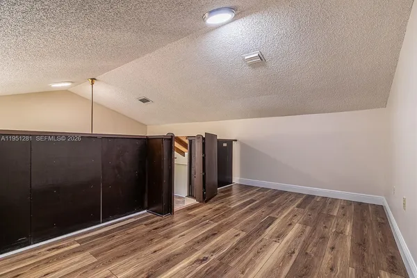a view of a room with wooden floor