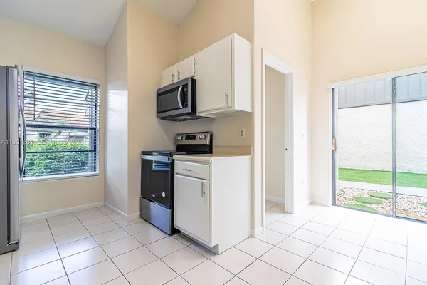a kitchen with stainless steel appliances a refrigerator and a stove