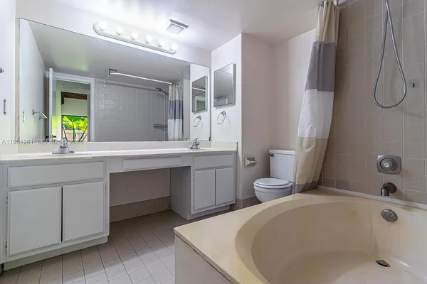 a bathroom with a tub sink and mirror