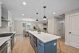 a kitchen with kitchen island a counter top space a sink stainless steel appliances and cabinets