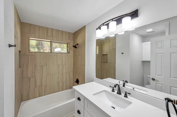 a bathroom with a sink a mirror and a bathtub