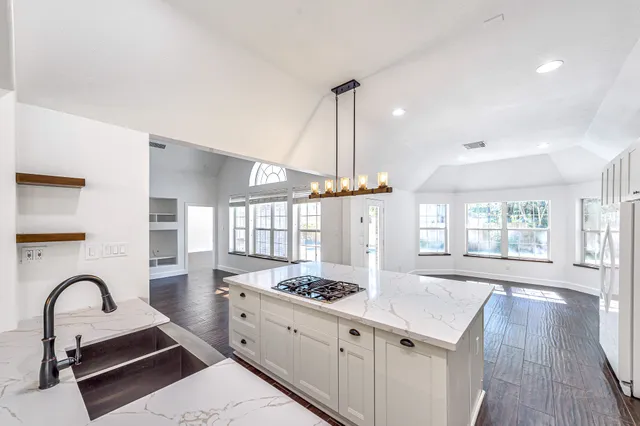 a kitchen with stainless steel appliances a sink and a stove