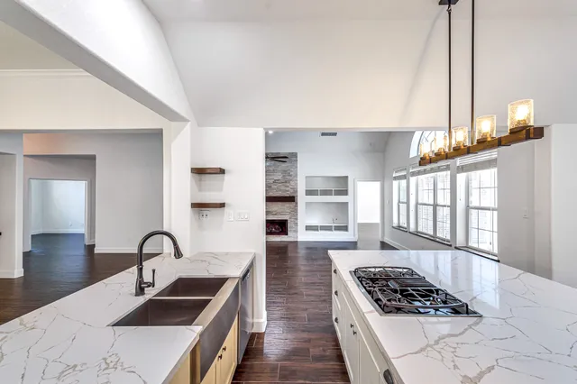 a kitchen with stainless steel appliances kitchen island a white stove top oven and sink