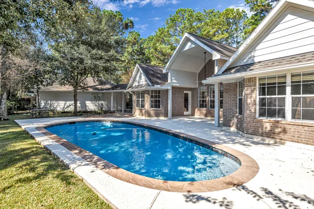 a view of a house with swimming pool and porch