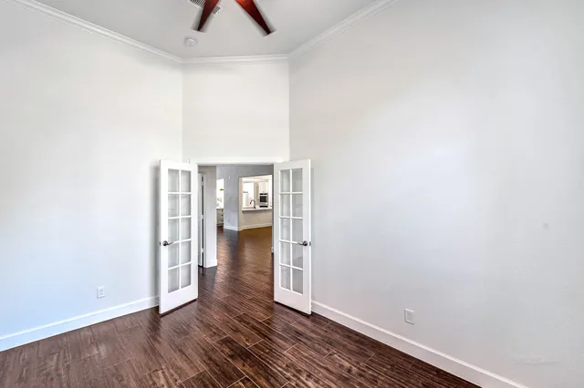 a view of empty room with wooden floor