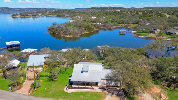 an aerial view of a house with a lake view
