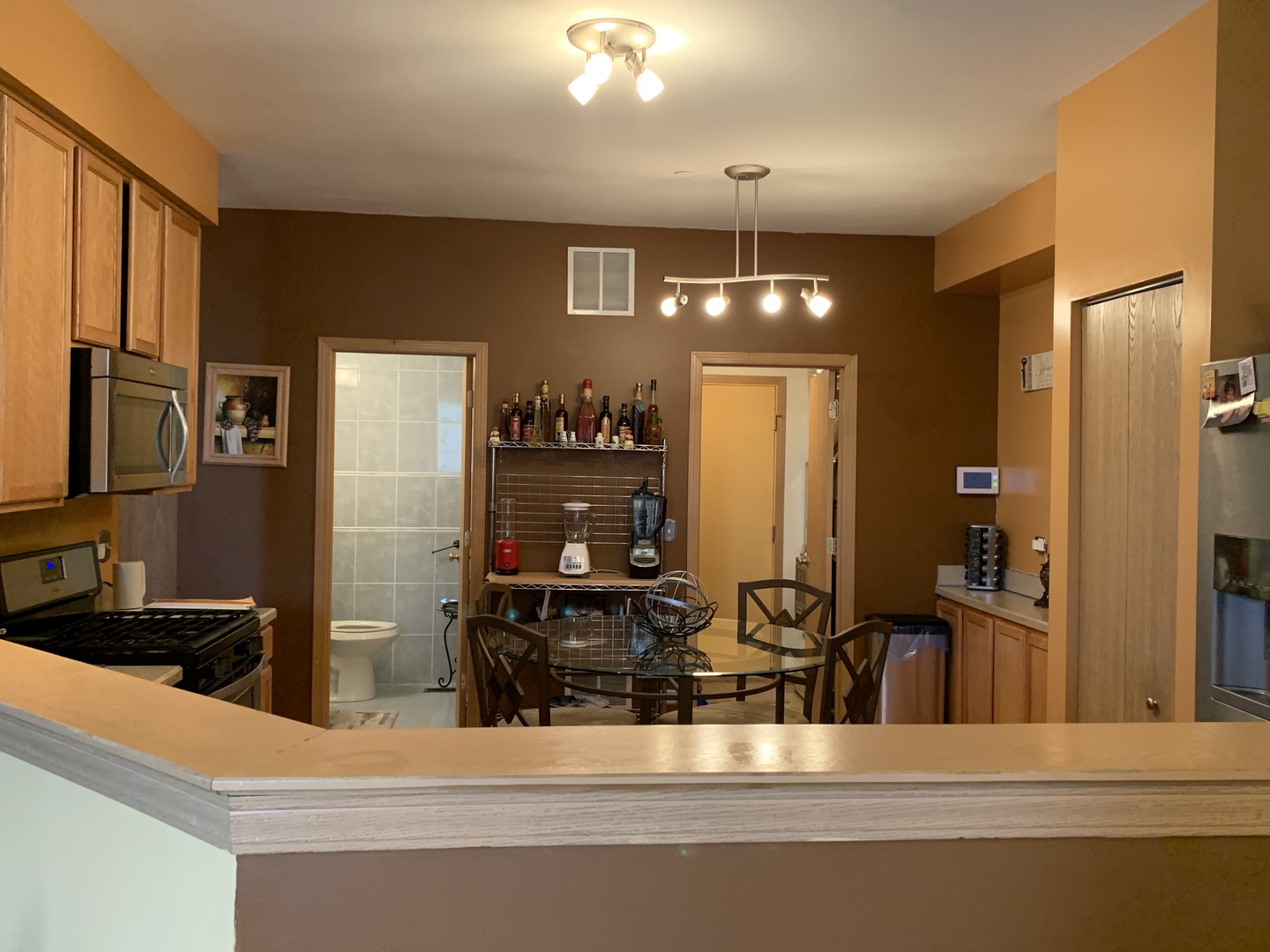 21211 Gray Hawk Drive Matteson, IL 60443 - Photo 12 of 36 a kitchen with stainless steel appliances kitchen island granite countertop a refrigerator and a sink