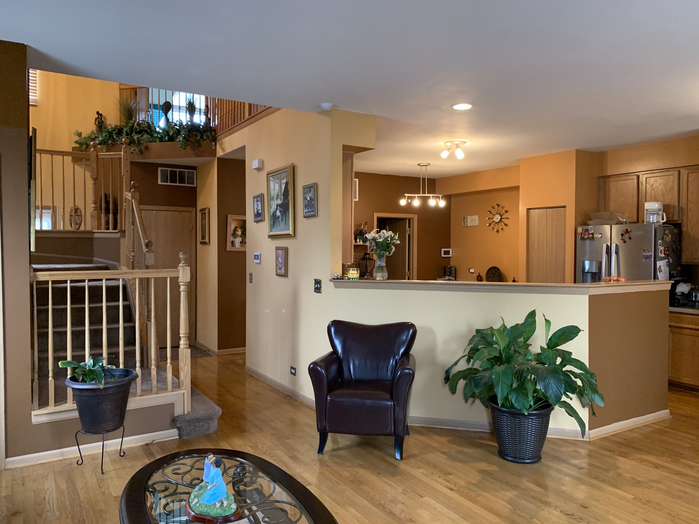 21211 Gray Hawk Drive Matteson, IL 60443 - Photo 6 of 36 a dining room with furniture potted plants and wooden floor