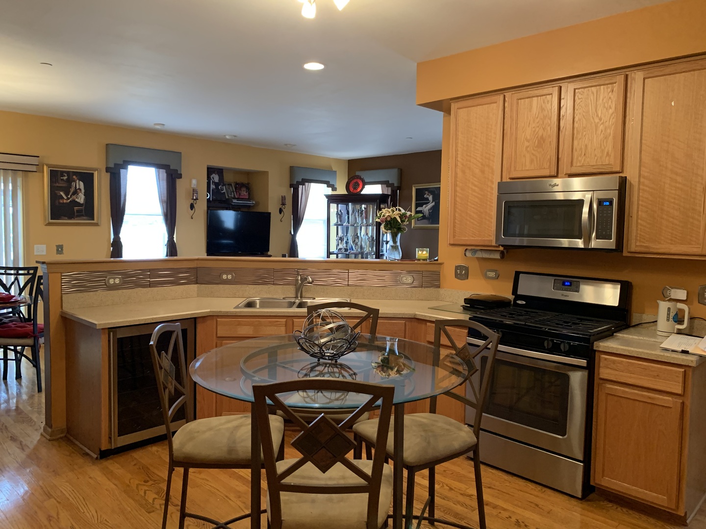 21211 Gray Hawk Drive Matteson, IL 60443 - Photo 8 of 36 a kitchen with a table chairs microwave and stove top oven