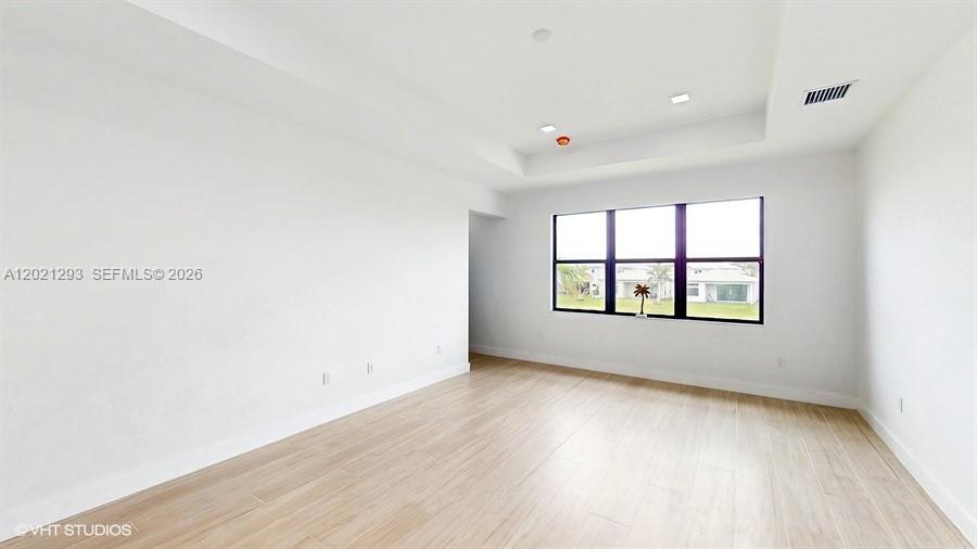 8350 Royal County Down Road Boca Raton, FL 33434 - Photo 20 of 52 an empty room with wooden floor and windows